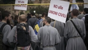 Together with hundreds of thousands of faithful Catholics, Friars hold banners reading "No to civil unions" at at rally in Rome on Jan. 30, 2016.